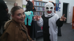 Parents and children exchanging Halloween costumes at a community swap event in London